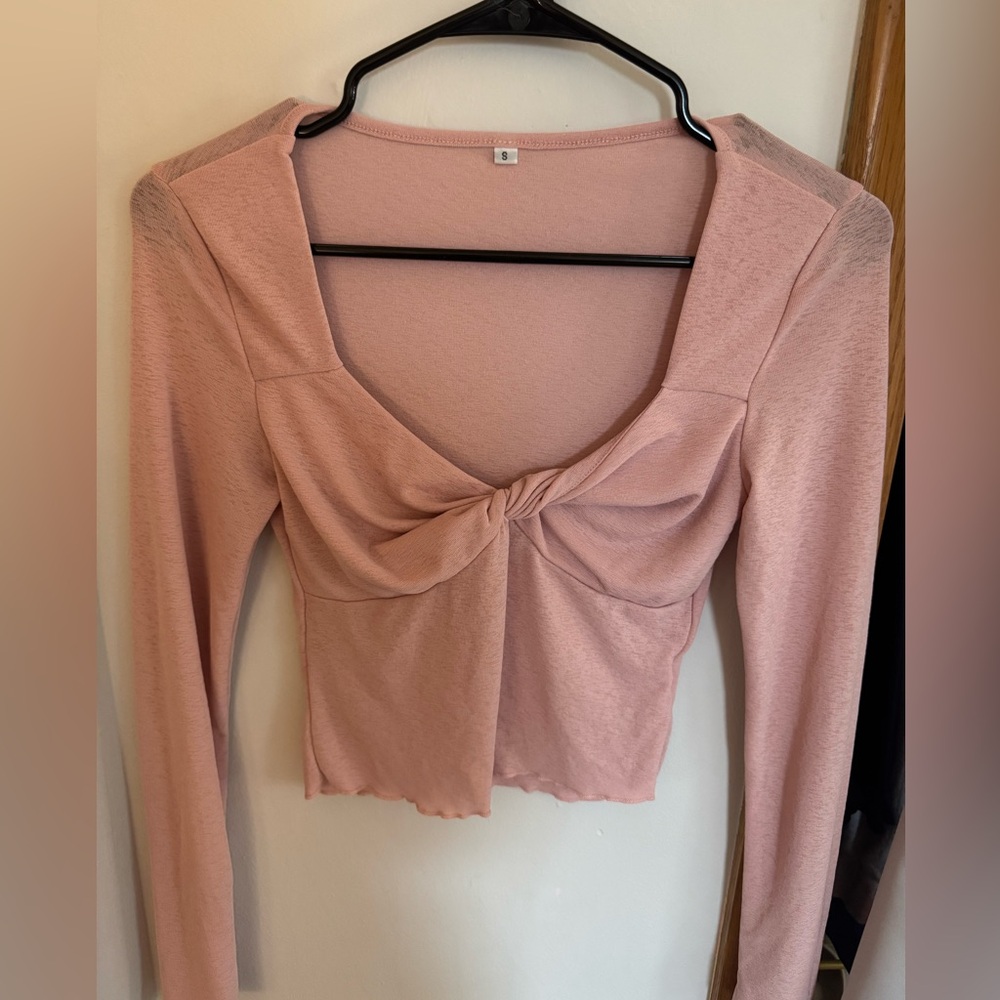 Pink long sleeve cropped shirt.